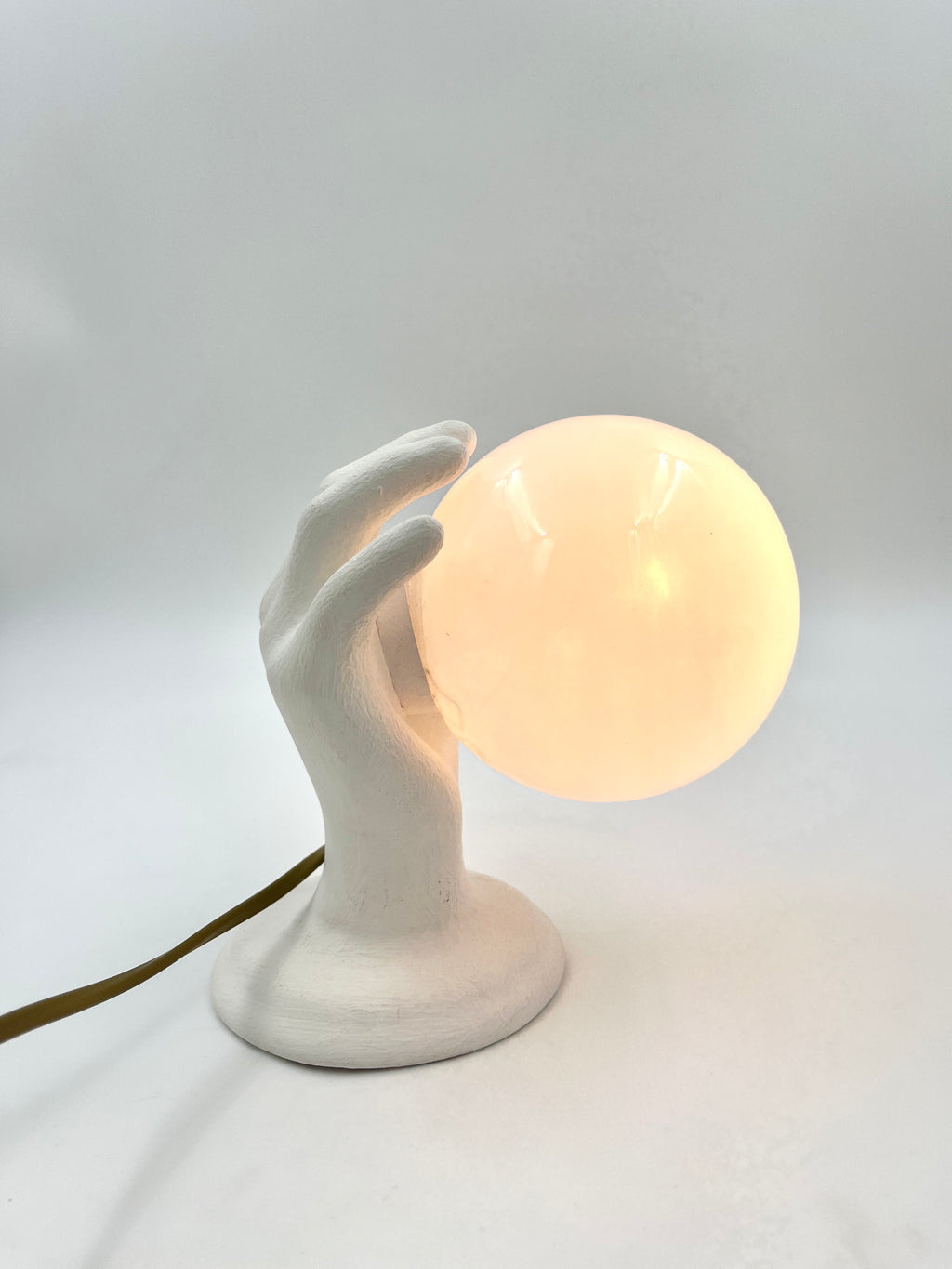 Vintage hand wall lamp with glass globe – sculptural design