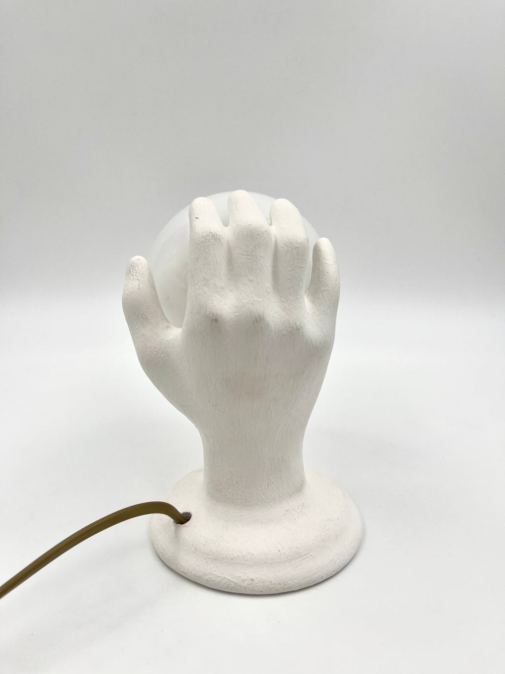 Vintage hand wall lamp with glass globe – sculptural design