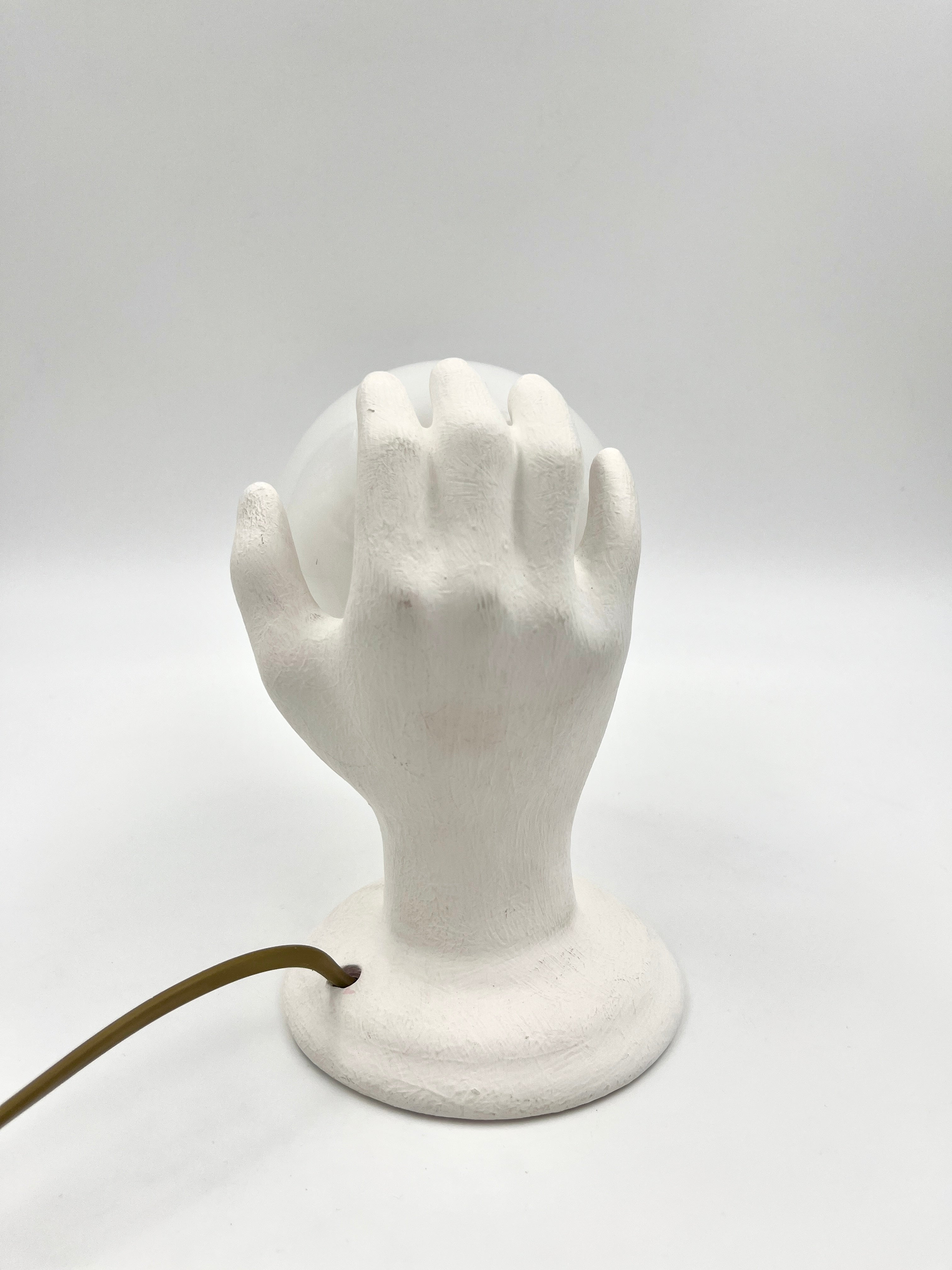 Vintage hand wall lamp with glass globe – sculptural design