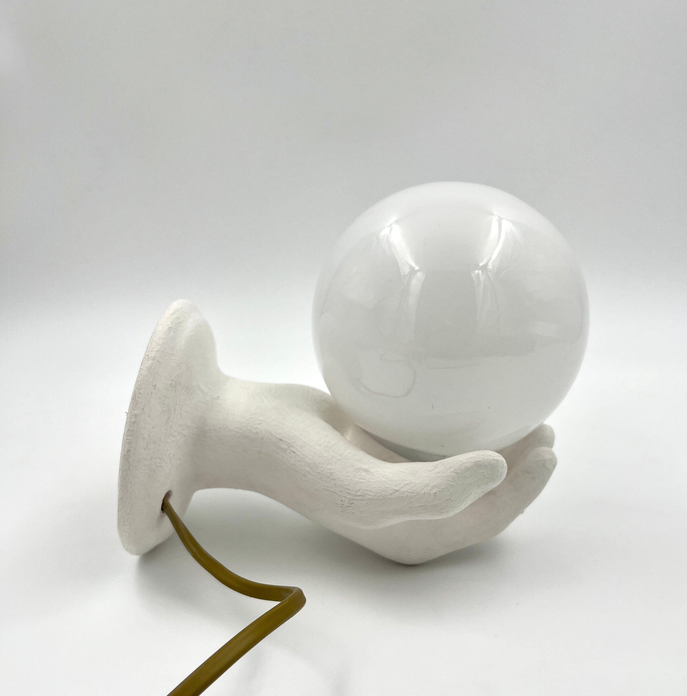 Vintage hand wall lamp with glass globe – sculptural design