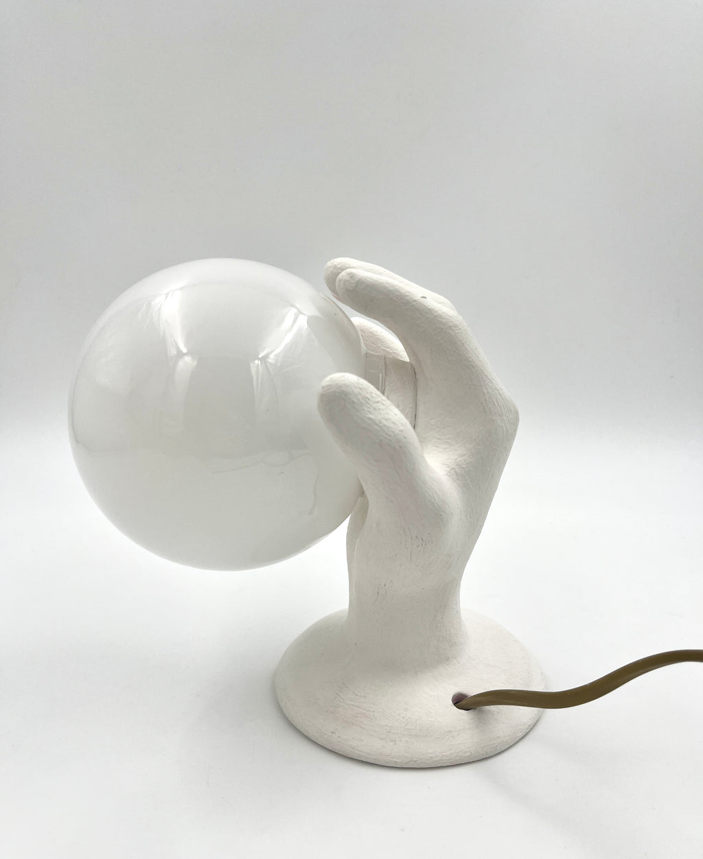 Vintage hand wall lamp with glass globe – sculptural design