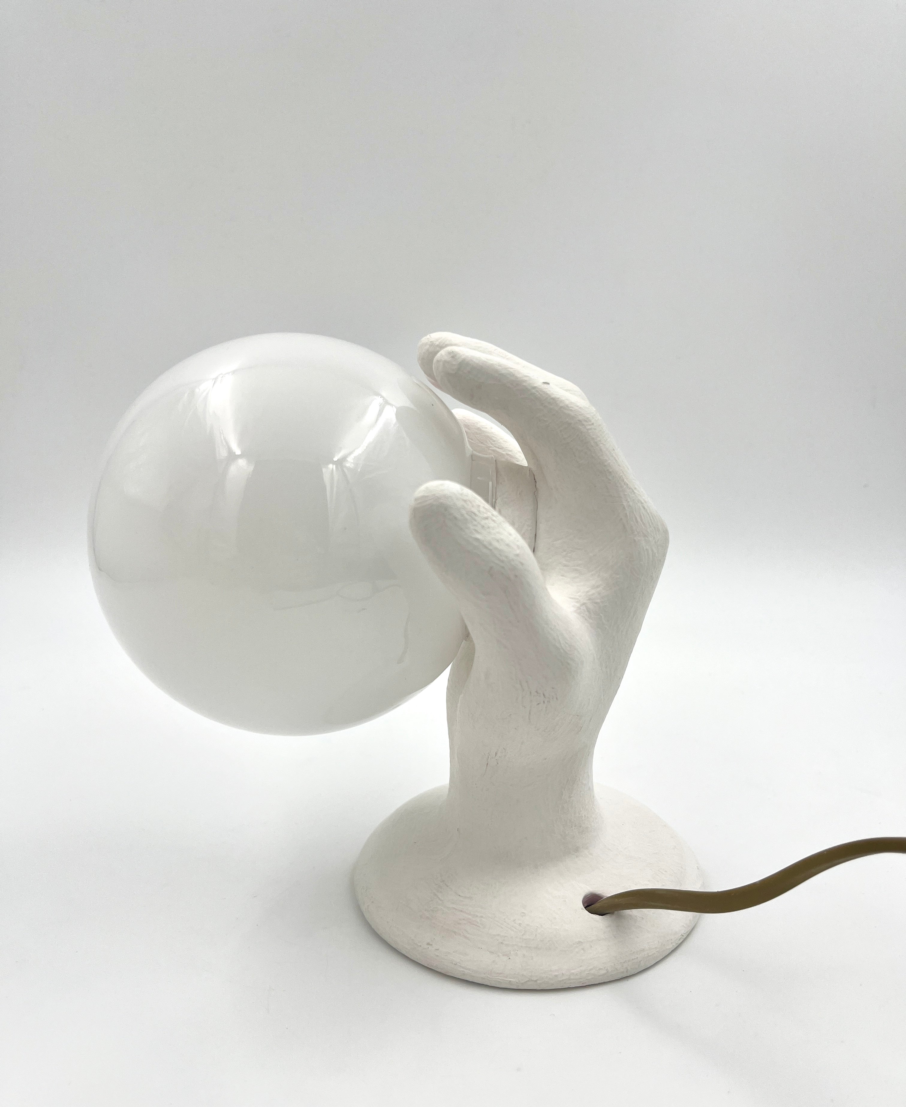 Vintage hand wall lamp with glass globe – sculptural design