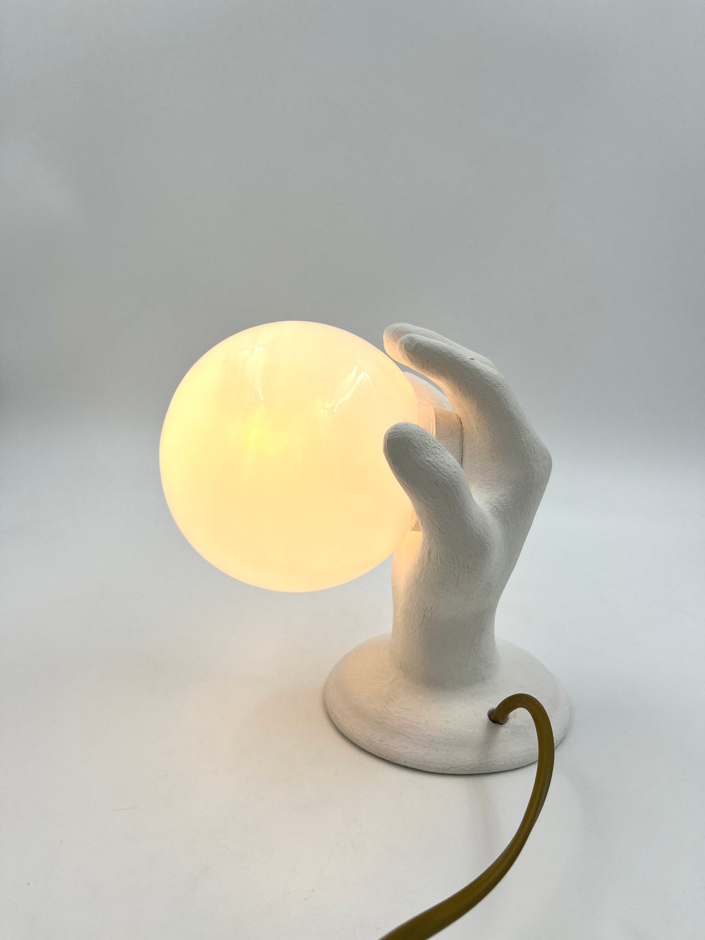 Vintage hand wall lamp with glass globe – sculptural design