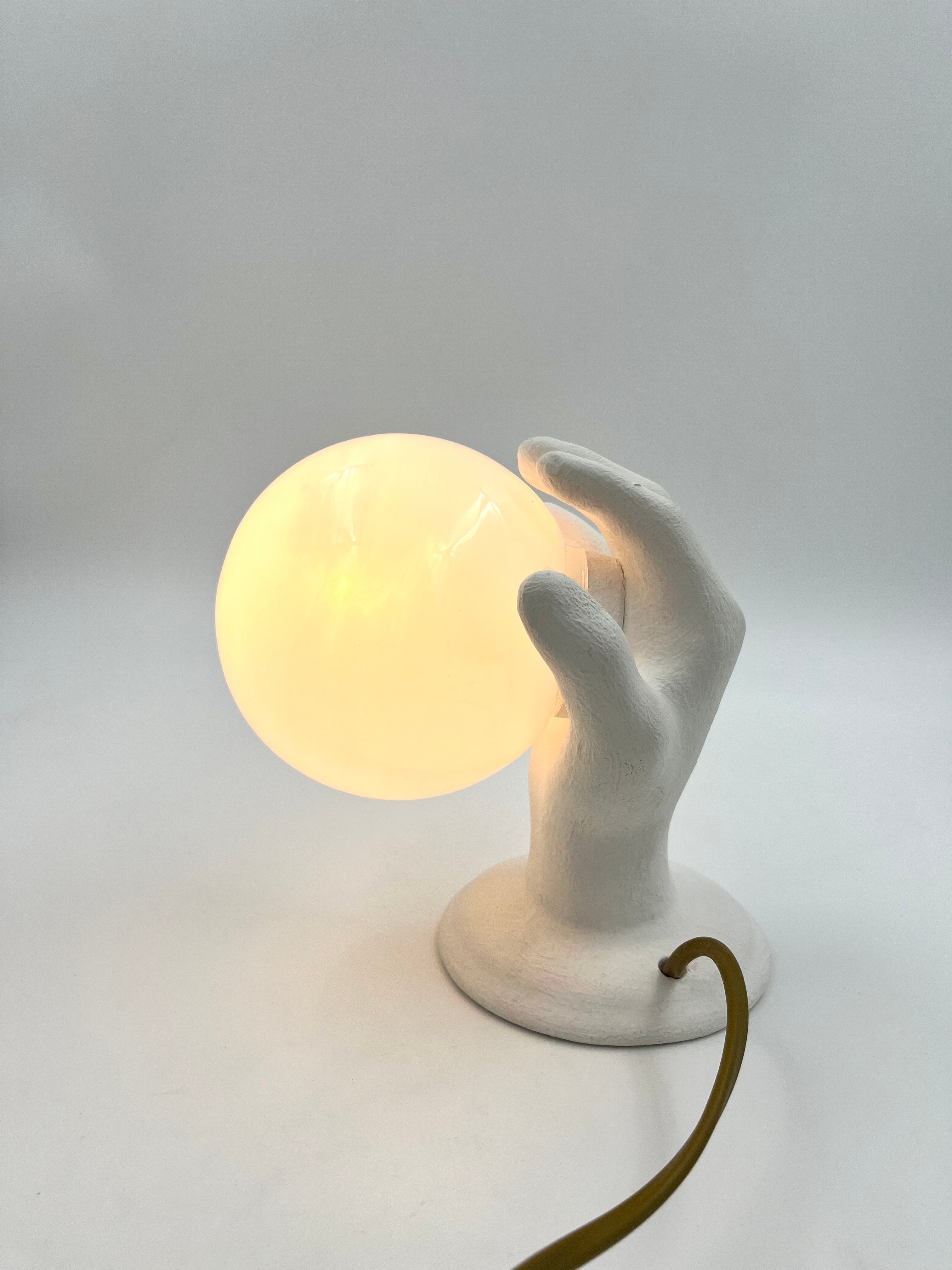 Vintage hand wall lamp with glass globe – sculptural design