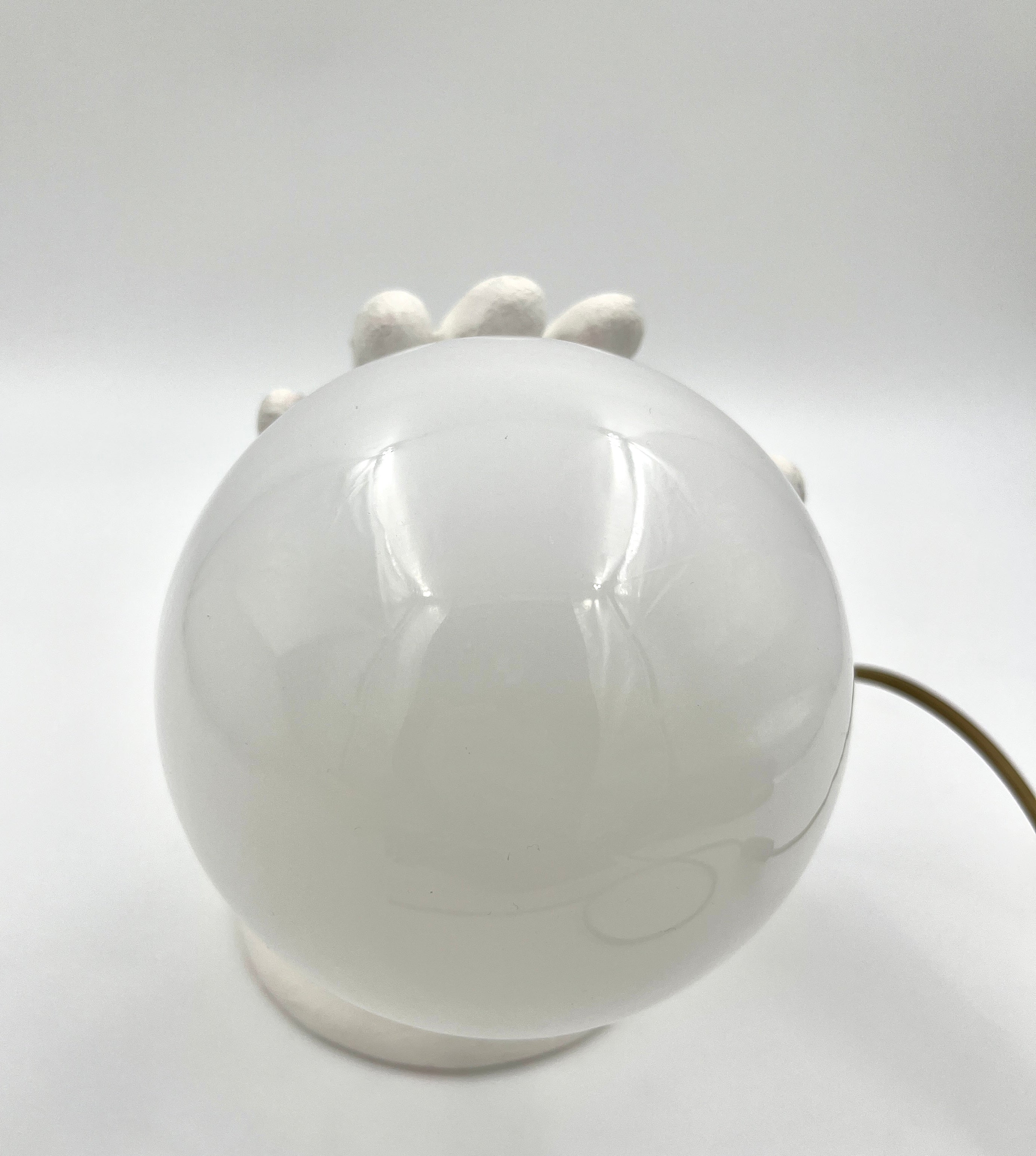 Vintage hand wall lamp with glass globe – sculptural design