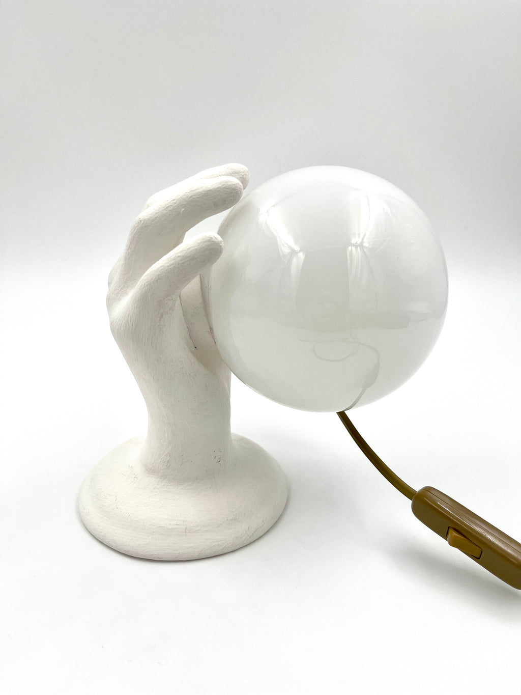 Vintage hand wall lamp with glass globe – sculptural design
