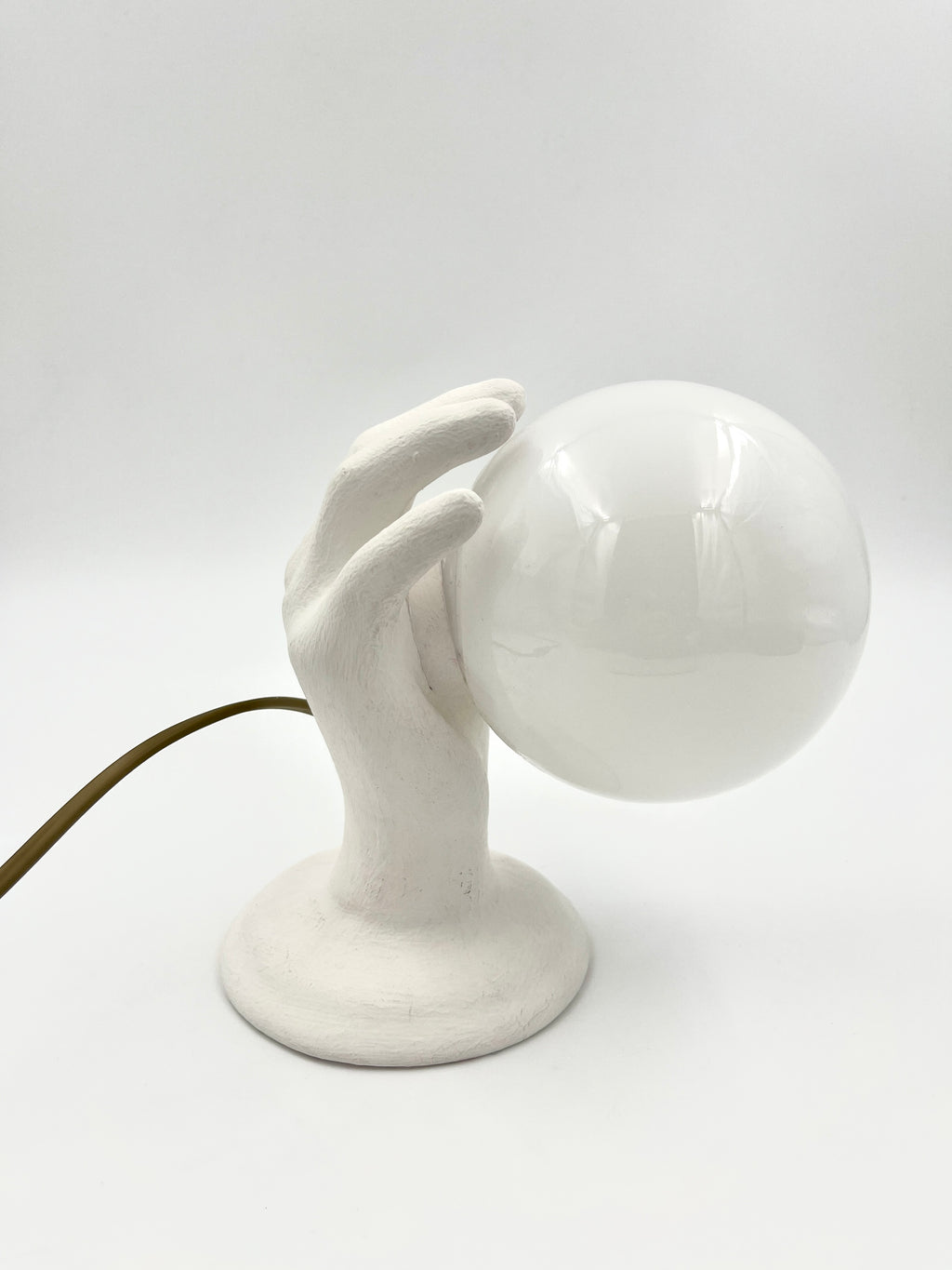 Vintage hand wall lamp with glass globe – sculptural design