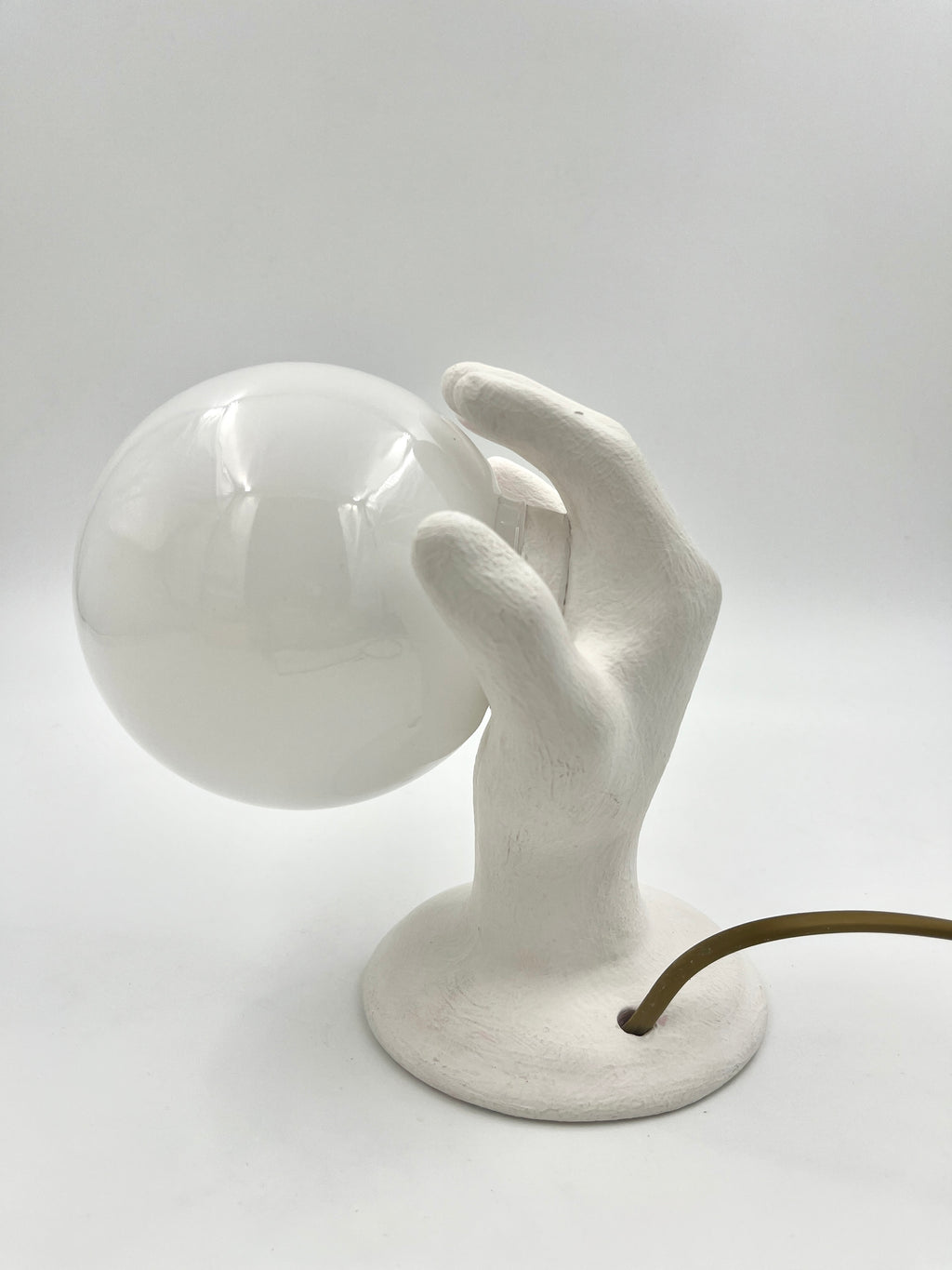 Vintage hand wall lamp with glass globe – sculptural design