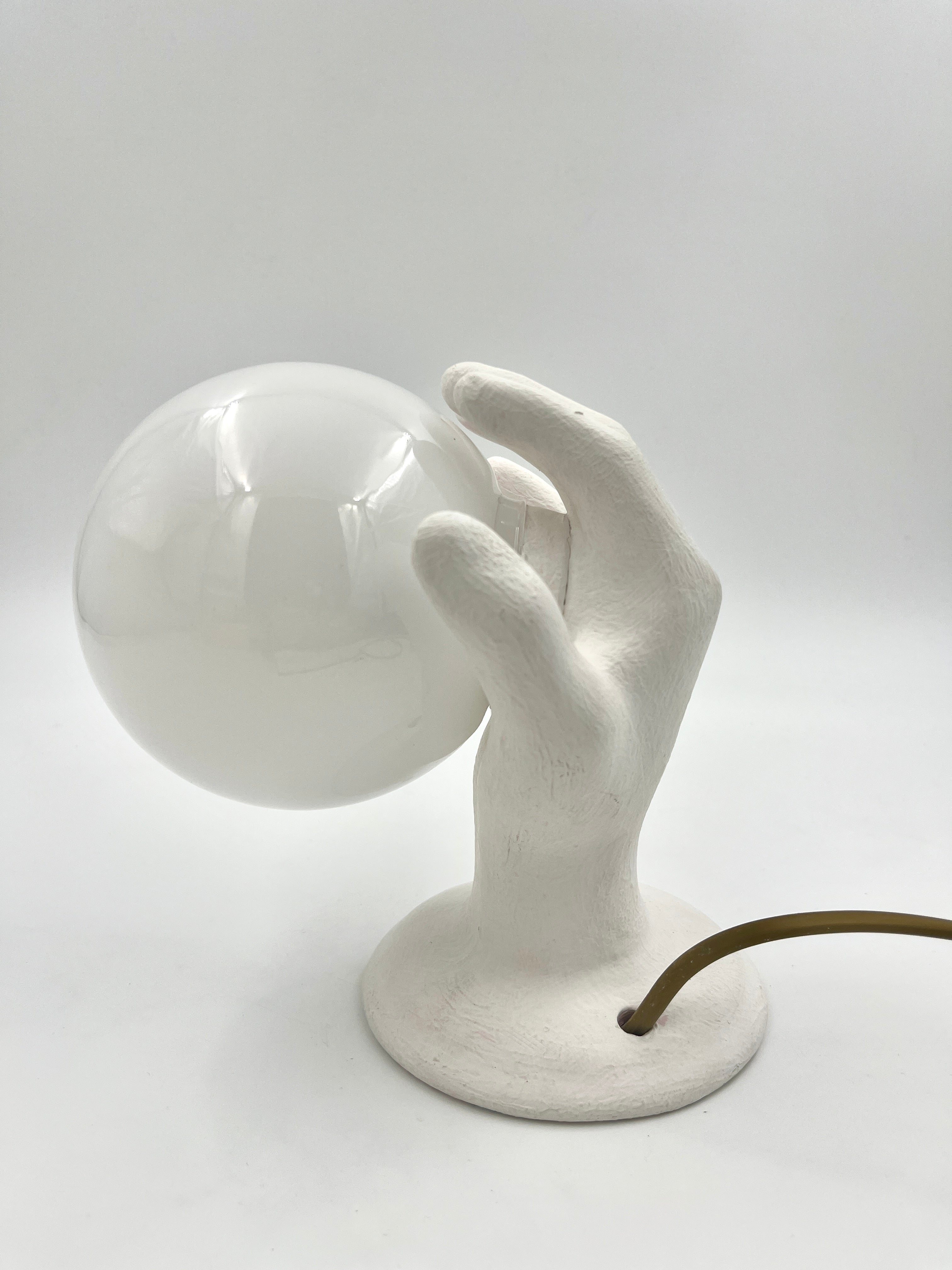 Vintage hand wall lamp with glass globe – sculptural design